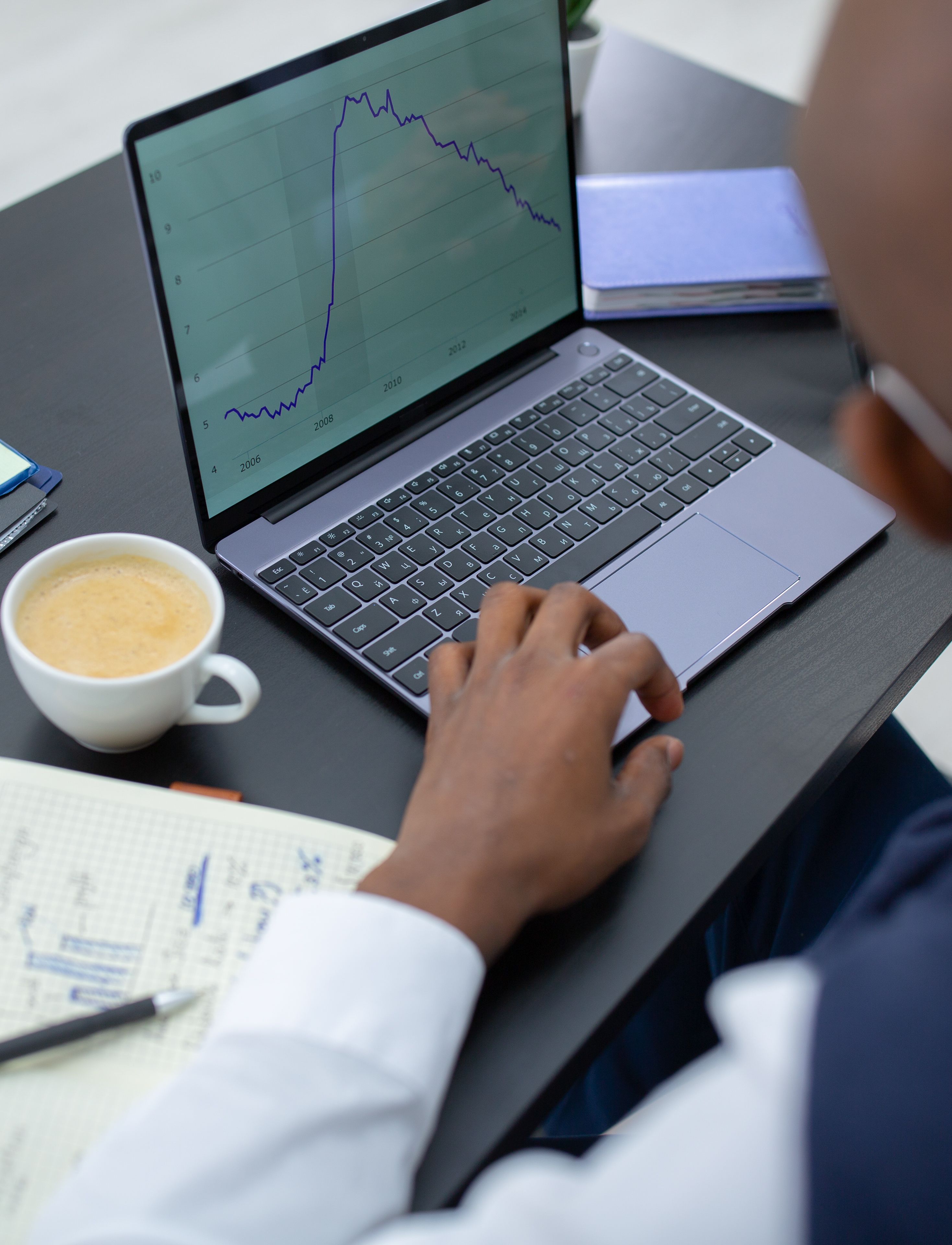 Accountant reviewing financial performance data on a laptop