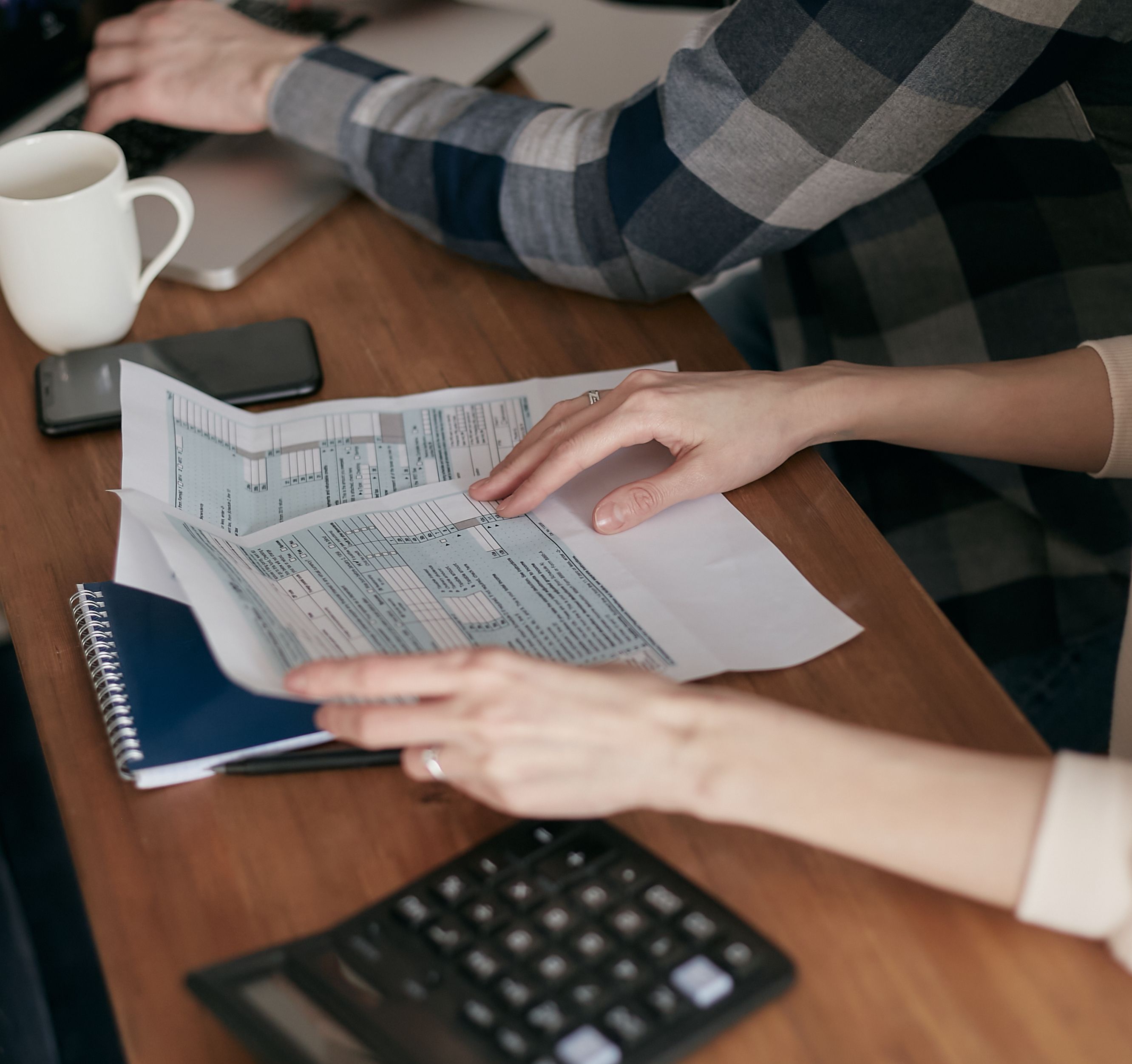 Reviewing tax paperwork and documents at a desk